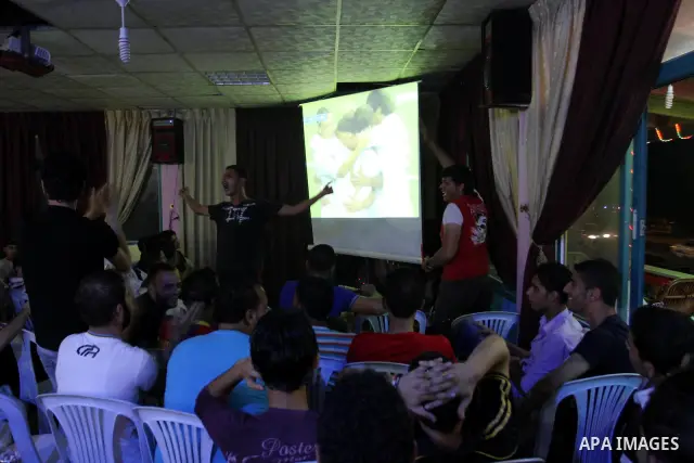 Palestinian Youths follow the match between Barcelona and Real Madrid Super Cup in a cafe yesterday evening in Gaza City on Aug. 14, 2011. Photo by Mohammed Asad