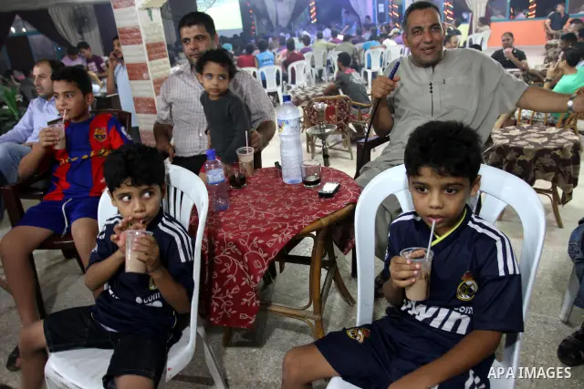 Palestinian Youths and boys follow the match between Barcelona and Real Madrid Super Cup in a cafe yesterday evening in Gaza City on Aug. 14, 2011. Photo by Mohammed Asad