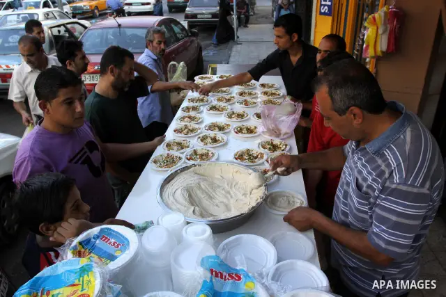 Palestinian vendors sell chickpeas in their shop in Gaza City on Aug. 15, 2011. Muslims around the world abstain from eating, drinking and conducting sexual relations from sunrise to sunset during Ramadan, the holiest mo...