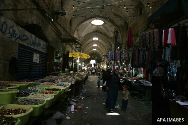 Palestinian women shop for clothes at a market, in Jerusalem's Old City during the holy month of Ramadan August 14, 2011. Muslims around the world are observing the holy fasting month of Ramadan in which they refrain fro...
