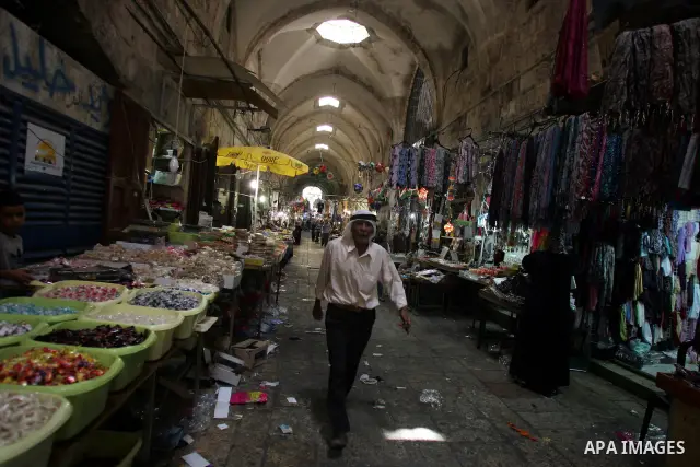 A Palestinian man walks at a market, in Jerusalem's Old City during the holy month of Ramadan August 14, 2011. Muslims around the world are observing the holy fasting month of Ramadan in which they refrain from eating, d...