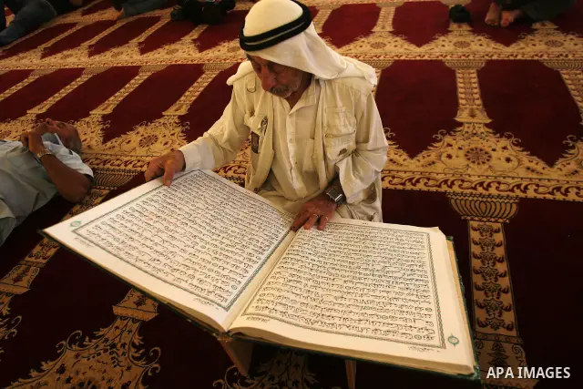 A Palestinian man reads the holy Koran in al-Aqsa Mosque, on the compound known to Muslims as al-Haram al-Sharif, in Jerusalem's Old City during the holy month of Ramadan August 14, 2011. Muslims around the world are obs...