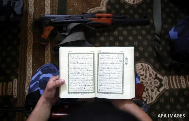 A Palestinian member of Hamas security reads a copy of the holy Koran in a Mosque during the holy month of Ramadan in Gaza Strip on 14 August 2011. Muslims around the world are observing the holy fasting month of Ramadan...