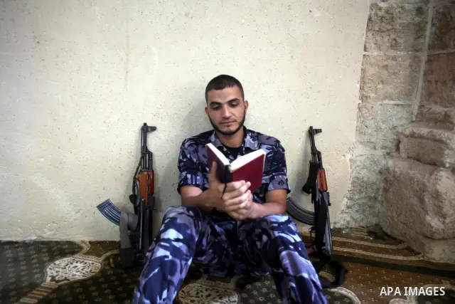 A Palestinian member of Hamas security reads a copy of the holy Koran in a Mosque during the holy month of Ramadan in Gaza Strip on 14 August 2011. Muslims around the world are observing the holy fasting month of Ramadan...