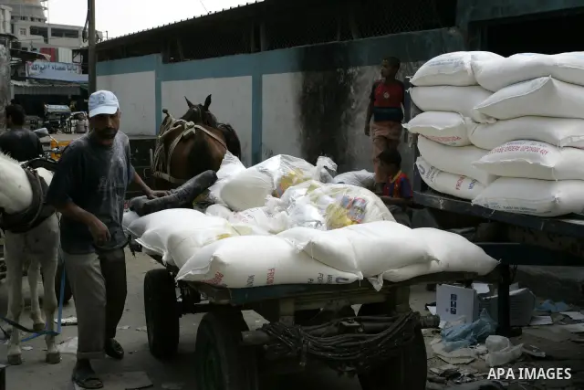 Palestinians receive food aids from the United Nations Relief and Works Agency (UNRWA) at the Rafah refugee camp, in the southern Gaza Strip on August 15, 2011. USAID halted humanitarian assistance to the Gaza Strip over...