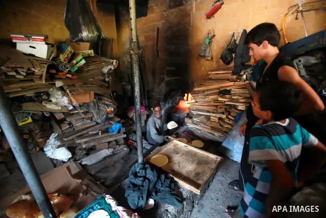 A Palestinian baker prepares loaves of bread at his traditional bakery in the holy month of Ramadan in Gaza City on Aug. 15, 2011. Muslims around the world abstain from eating, drinking and conducting sexual relations fr...