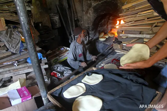 A Palestinian baker prepares loaves of bread at his traditional bakery in the holy month of Ramadan in Gaza City on Aug. 15, 2011. Muslims around the world abstain from eating, drinking and conducting sexual relations fr...