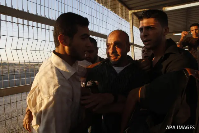 Palestinians welcome back of prisoner Ahmed Abu El-Kass released from Israeli prisons at the Erez checkpoint in the northern Gaza Strip, following their release at the Erez crossing by Israeli border police, 15 August 20...
