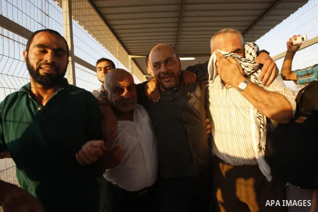 Palestinians welcome back of prisoner Ahmed Abu El-Kass released from Israeli prisons at the Erez checkpoint in the northern Gaza Strip, following their release at the Erez crossing by Israeli border police, 15 August 20...