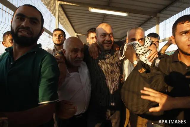 Palestinians welcome back of prisoner Ahmed Abu El-Kass released from Israeli prisons at the Erez checkpoint in the northern Gaza Strip, following their release at the Erez crossing by Israeli border police, 15 August 20...