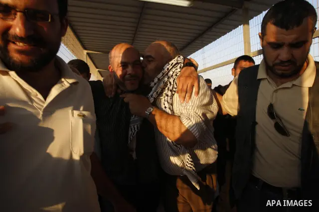 Palestinians welcome back of prisoner Ahmed Abu El-Kass released from Israeli prisons at the Erez checkpoint in the northern Gaza Strip, following their release at the Erez crossing by Israeli border police, 15 August 20...