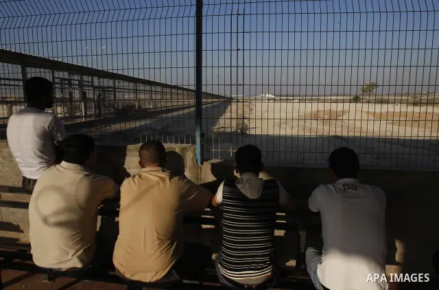 Palestinians Wait back of prisoner Belal Baker released from Israeli prisons at the Erez checkpoint in the northern Gaza Strip, following their release at the Erez crossing by Israeli border police, 15 August 2011. In to...