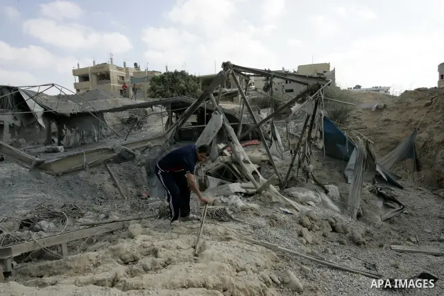 Palestinians inspect the damage outside a smuggling tunnel following an overnight Israeli airstrike in Rafah, on the border between Egypt and southern Gaza Strip, Tuesday on Aug. 16, 2011. after one Palestinian was kille...