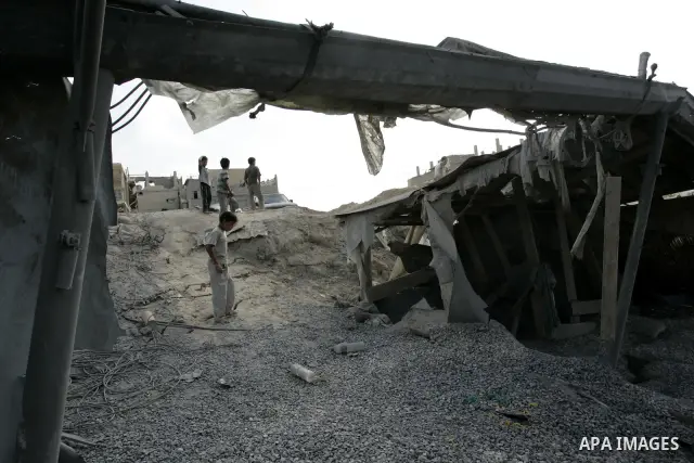 Palestinians inspect the damage outside a smuggling tunnel following an overnight Israeli airstrike in Rafah, on the border between Egypt and southern Gaza Strip, Tuesday on Aug. 16, 2011. after one Palestinian was kille...