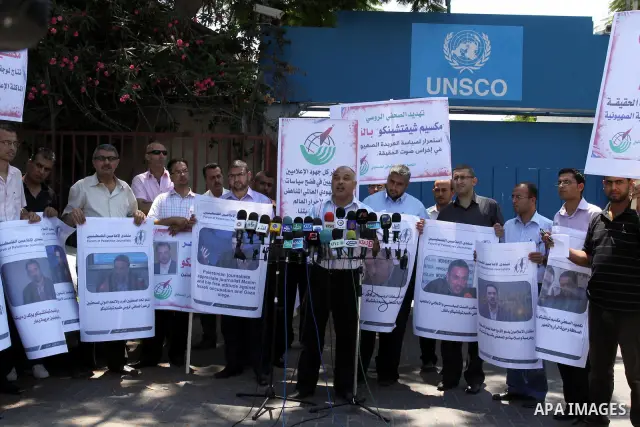 Palestinian journalists deliver speech in a protest in support with the Russian journalist, Maxim infront of UNSCO in Gaza city on Aug. 16, 2011. where he threatened with death by one of the leaders of the Russian Jewish...