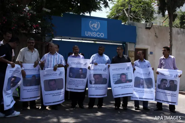 Palestinian journalists take part in a protest in support with the Russian journalist, Maxim infront of UNSCO in Gaza city on Aug. 16, 2011. where he threatened with death by one of the leaders of the Russian Jewish Cong...