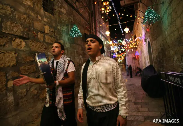 Palestinian youths use a traditional drum to wake up people for their Suhoor in a narrow street leading to the al-Aqsa Mosque in Jerusalem's Old City on August 16,2011, during the sixteenth day of the Muslim holy month o...