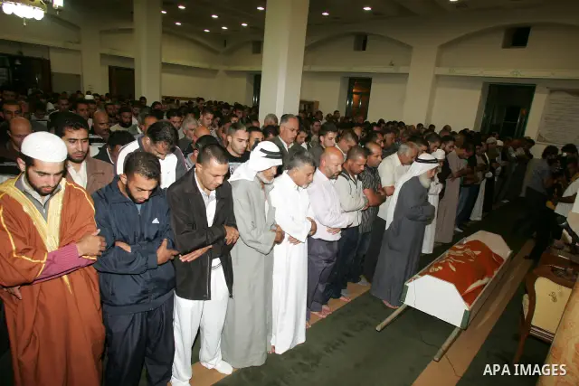 Relatives and friends of the Palestinian Amin Taleb Dabash, 32, pray at his body during his funeral in the village of Sur Baher in east Jerusalem on August 17,2011. Dabash was killed after an Israeli military jeep hit hi...
