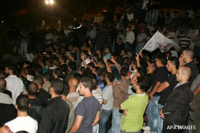 Relatives and friends of the Palestinian Amin Taleb Dabash, 32, mourn during his funeral in the village of Sur Baher in east Jerusalem on August 17,2011. Dabash was killed after an Israeli military jeep hit him . Photo b...