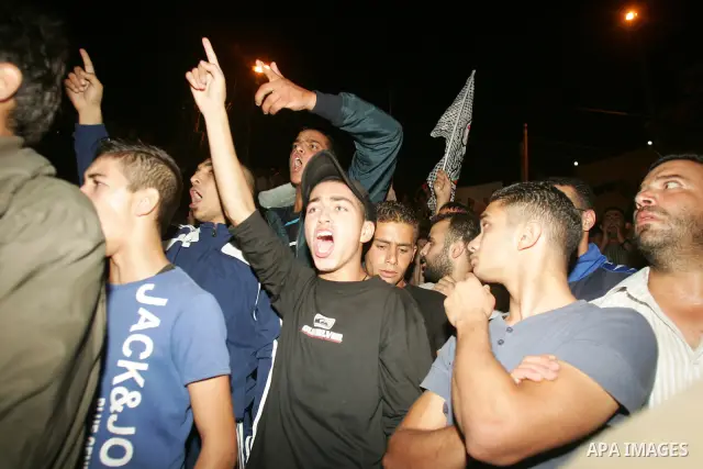 Relatives and friends of the Palestinian Amin Taleb Dabash, 32, mourn during his funeral in the village of Sur Baher in east Jerusalem on August 17,2011. Dabash was killed after an Israeli military jeep hit him . Photo b...