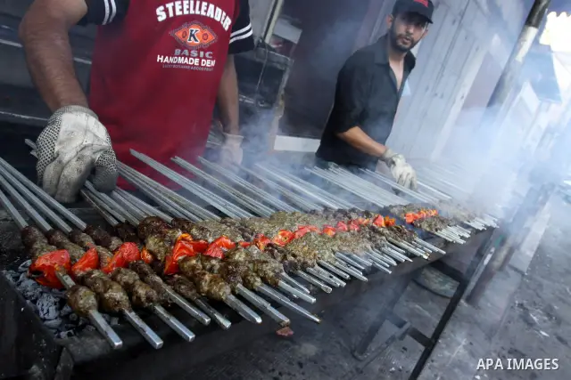 A Palestinian vendor sells grilled meat "Kebabs" in his shop in Gaza city on Aug. 16, 2011. Muslims around the world abstain from eating, drinking and conducting sexual relations from sunrise to sunset during Ramadan, th...