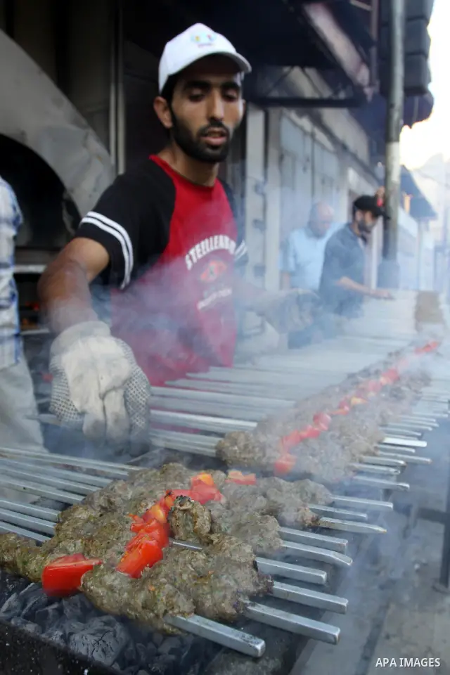A Palestinian vendor sells grilled meat "Kebabs" in his shop in Gaza city on Aug. 16, 2011. Muslims around the world abstain from eating, drinking and conducting sexual relations from sunrise to sunset during Ramadan, th...