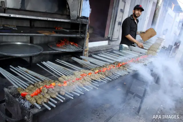 A Palestinian vendor sells grilled meat "Kebabs" in his shop in Gaza city on Aug. 16, 2011. Muslims around the world abstain from eating, drinking and conducting sexual relations from sunrise to sunset during Ramadan, th...