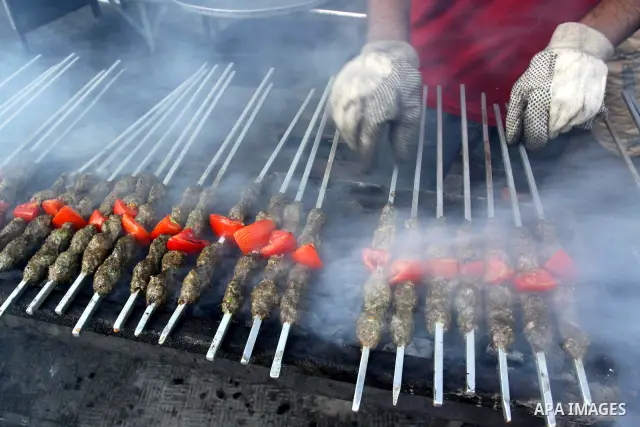 A Palestinian vendor sells grilled meat "Kebabs" in his shop in Gaza city on Aug. 16, 2011. Muslims around the world abstain from eating, drinking and conducting sexual relations from sunrise to sunset during Ramadan, th...