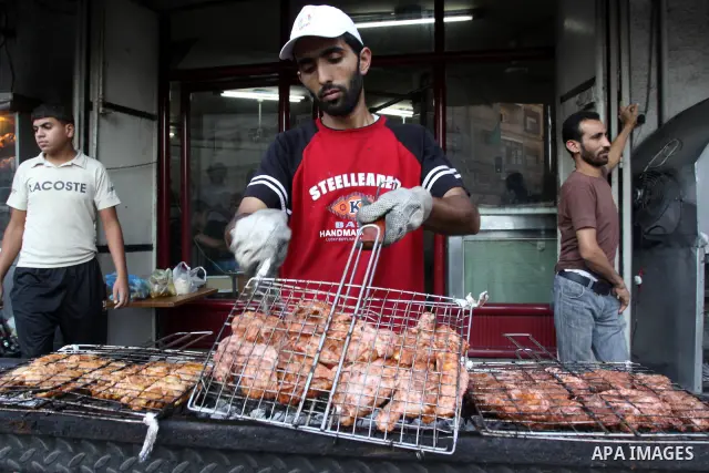 A Palestinian vendor prepares chicken at his shop in Gaza City on Aug. 16, 2011. Muslims around the world abstain from eating, drinking and conducting sexual relations from sunrise to sunset during Ramadan, the holiest m...