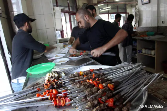 A Palestinian vendor prepares grilled meat "kebabs" at his butchery in Gaza City on Aug. 16, 2011. Muslims around the world abstain from eating, drinking and conducting sexual relations from sunrise to sunset during Rama...