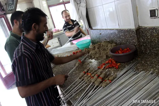 A Palestinian vendor prepares grilled meat "kebabs" at his butchery in Gaza City on Aug. 16, 2011. Muslims around the world abstain from eating, drinking and conducting sexual relations from sunrise to sunset during Rama...