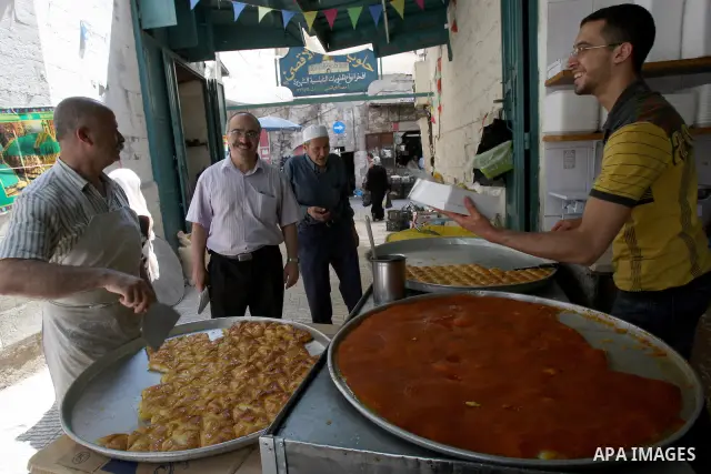 A Palestinian vendor sells the traditional sweets in his shop during the holy month of Ramadan in the West Bank city of Nablus on Aug. 17, 2011. Muslims around the world are observing the holy fasting month of Ramadan in...