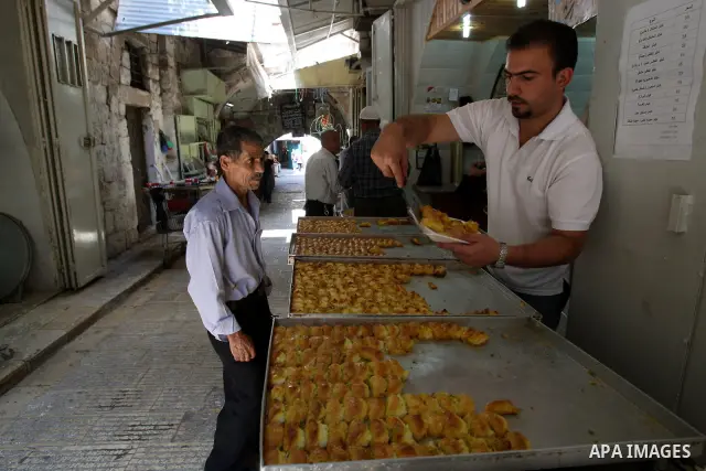 A Palestinian vendor sells the traditional sweets in his shop during the holy month of Ramadan in the West Bank city of Nablus on Aug. 17, 2011. Muslims around the world are observing the holy fasting month of Ramadan in...