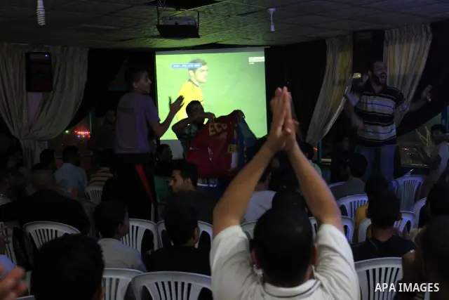 Palestinian Youths follow the Spanish Super Cup at a cafe, yesterday evening in Gaza City on Aug. 17, 2011. Photo by Mohammed Asad