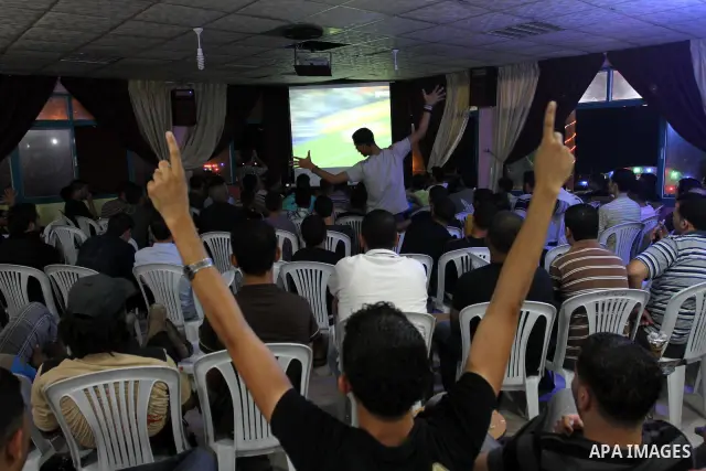 Palestinian Youths follow the Spanish Super Cup at a cafe, yesterday evening in Gaza City on Aug. 17, 2011. Photo by Mohammed Asad