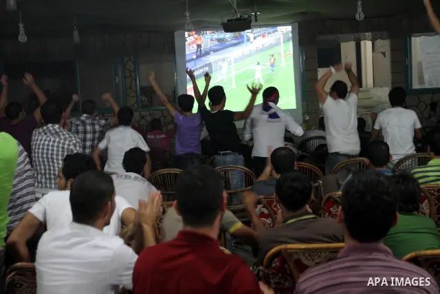 Palestinian Youths follow the Spanish Super Cup at a cafe, yesterday evening in Gaza City on Aug. 17, 2011. Photo by Mohammed Asad