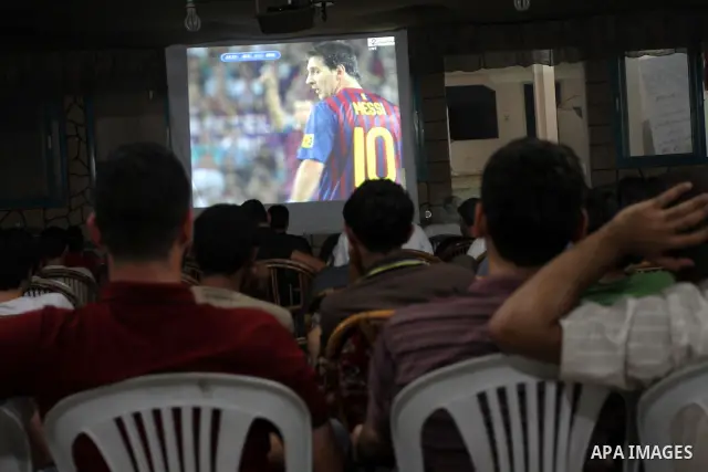 Palestinian Youths follow the Spanish Super Cup at a cafe, yesterday evening in Gaza City on Aug. 17, 2011. Photo by Mohammed Asad