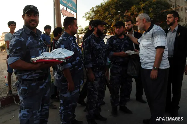 Palestinian Prime Minister in Gaza Strip, Ismail Haniya participates in the meal of "Iftar" with Hamas police, during the seventeenth day of the holiest month of Ramadan in Gaza City on Aug. 17, 2011. Photo by Ahmed Shaa...