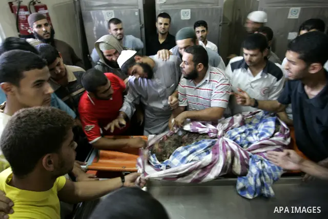Palestinians look at the body of militant Kamal al-Nayrab, secretary-general of the Gaza-based group the Popular Resistance Committees (PRC), at the morgue in the al-Najar Hospital in the southern Gaza Strip town of Rafa...