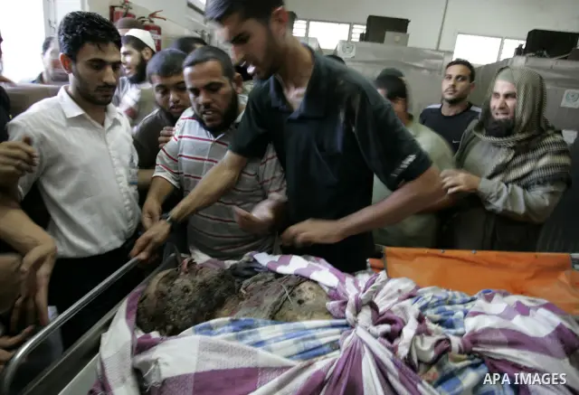 Palestinians look at the body of militant Kamal al-Nayrab, secretary-general of the Gaza-based group the Popular Resistance Committees (PRC), at the morgue in the al-Najar Hospital in the southern Gaza Strip town of Rafa...