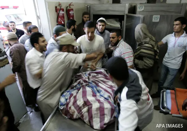 Palestinians look at the body of militant Kamal al-Nayrab, secretary-general of the Gaza-based group the Popular Resistance Committees (PRC), at the morgue in the al-Najar Hospital in the southern Gaza Strip town of Rafa...