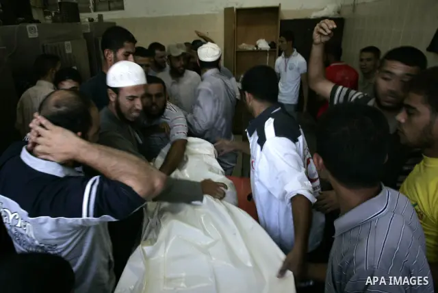 Palestinians react at a hospital after an Israeli air strike in Rafah in the southern Gaza Strip August 18, 2011. An Israeli air strike killed the leader of an armed Palestinian faction, a top lieutenant and three other...