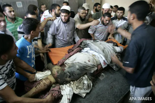 Palestinians react at a hospital after an Israeli air strike in Rafah in the southern Gaza Strip August 18, 2011. An Israeli air strike killed the leader of an armed Palestinian faction, a top lieutenant and three other...