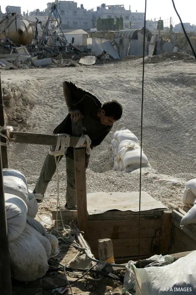 A Palestinian inspects the damage to a smuggling tunnel after it was targeted in an Israeli air strike in Rafah, in the southern Gaza Strip August 19, 2011. Israeli aircraft struck Hamas security installations in Gaza on...