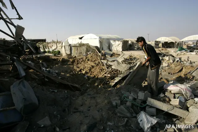 A Palestinian inspects the damage to a smuggling tunnel after it was targeted in an Israeli air strike in Rafah, in the southern Gaza Strip August 19, 2011. Israeli aircraft struck Hamas security installations in Gaza on...