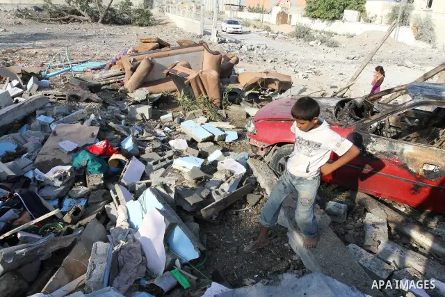 Palestinians stand over a destroyed house after an Israeli air strike in Gaza city August 19, 2011. Israeli aircraft struck Hamas security installations in Gaza on Friday, killing at least one Palestinian, in further ret...