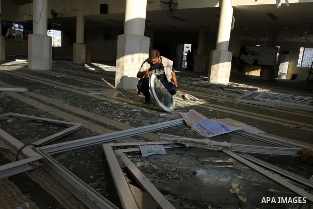 A Palestinian man surveys the damage in Bin Zayed mosque after an Israeli air strike in Gaza August 19, 2011. Israeli aircraft struck Hamas security installations in Gaza on Friday, killing at least one Palestinian, in f...