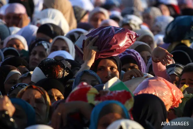 Palestinian women wait to cross the Qalandia checkpoint on their way to pray at the Al Aqsa Mosque on the third Friday of the Muslim holy month of Ramadan, at the Qalandia checkpoint between the West Bank city of Ramalla...