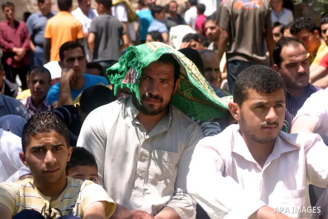 Palestinians attend the third friday prayer of Islam's holy fasting month of Ramadan outside the Ibrahimi mosque, or the Tomb of the Patriarchs, in the divided West Bank city of Hebron on August 19, 2011. Photo by Najeh...