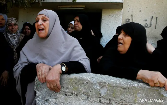 Palestinian relatives of Khaled Sha'at, a member of an armed Palestinian faction, and his two-year-old son Malek mourn during their funeral in Rafah in the southern Gaza Strip August 19, 2011. The Israeli air strike kill...